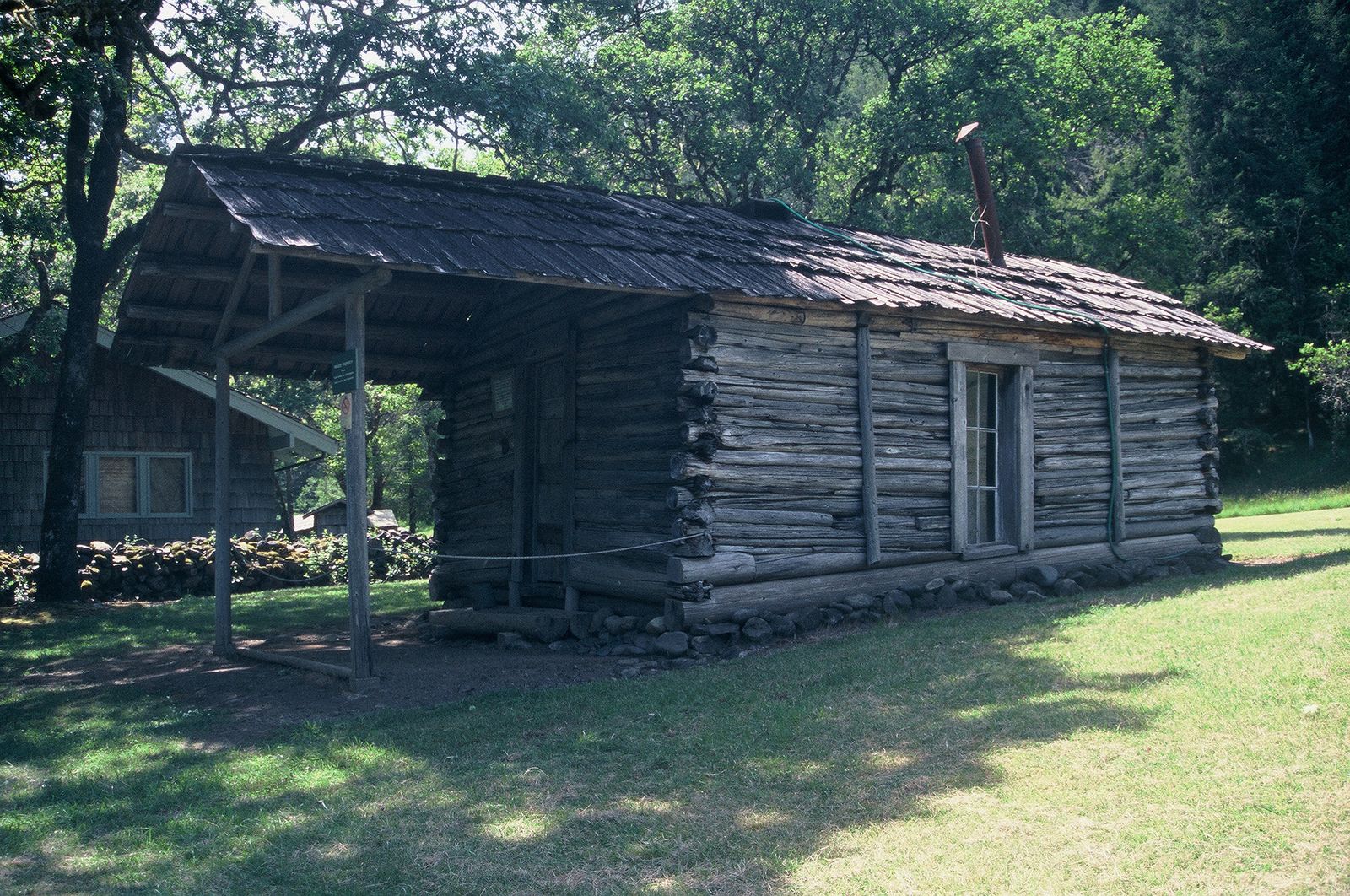 A remote wooden cabin standing alone among trees
