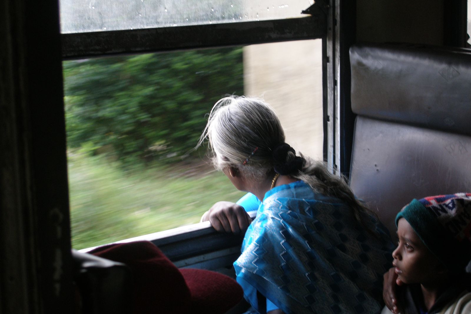 A train on the hill country railway line winding through tea estates in Sri Lanka