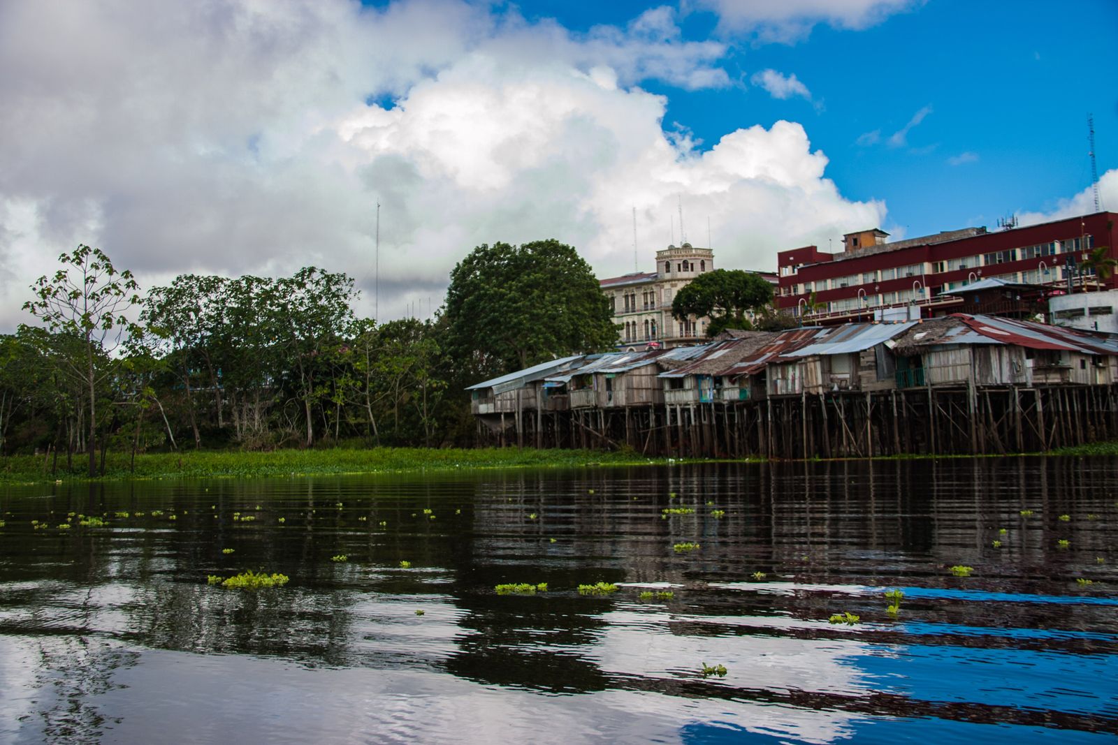 The wide, muddy Amazon River at Iquitos, Peru, with boats along its banks