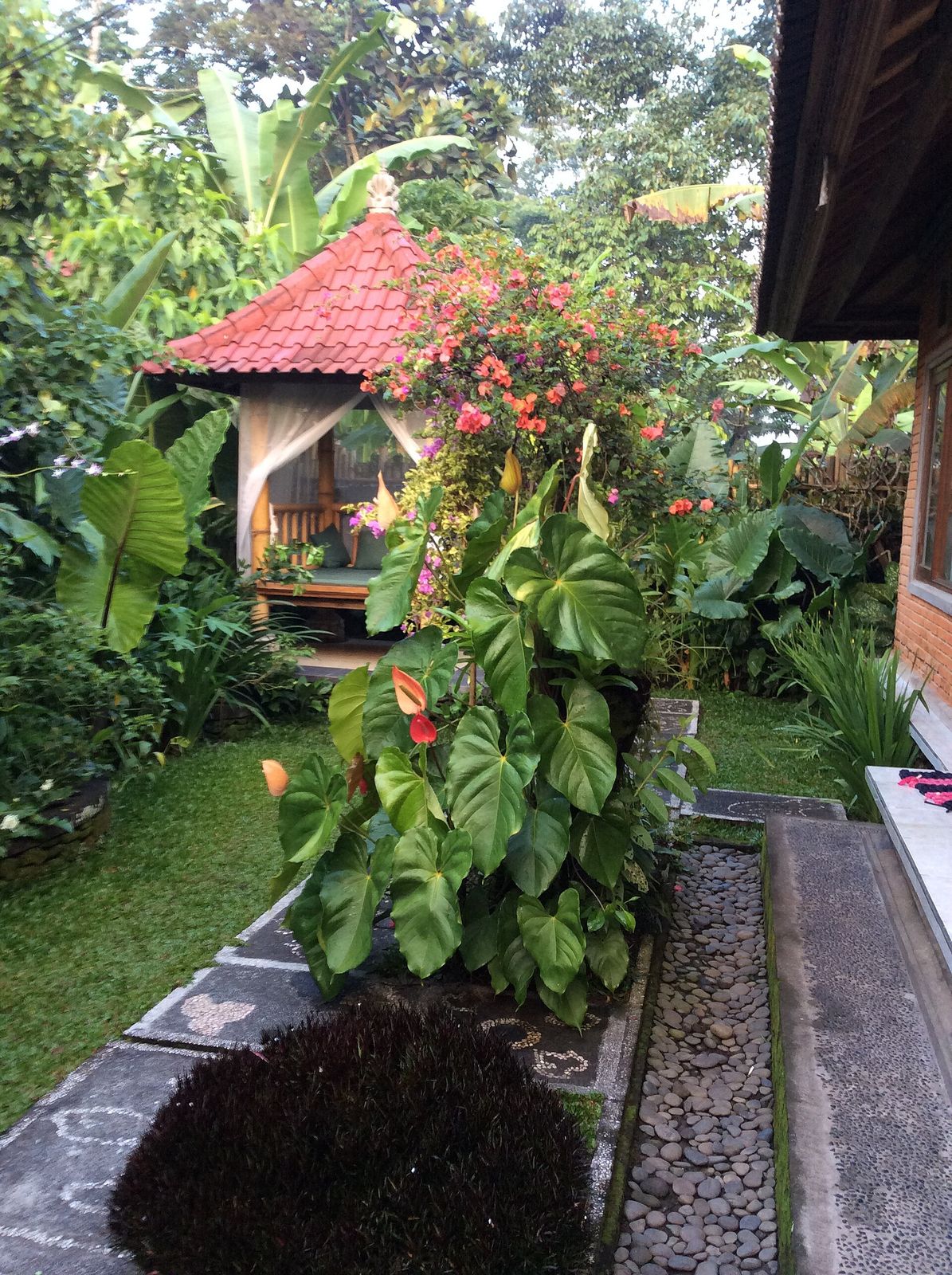 The stepped green rice terraces of Tegallalang near Ubud, Bali, with palm trees along the steepest banks